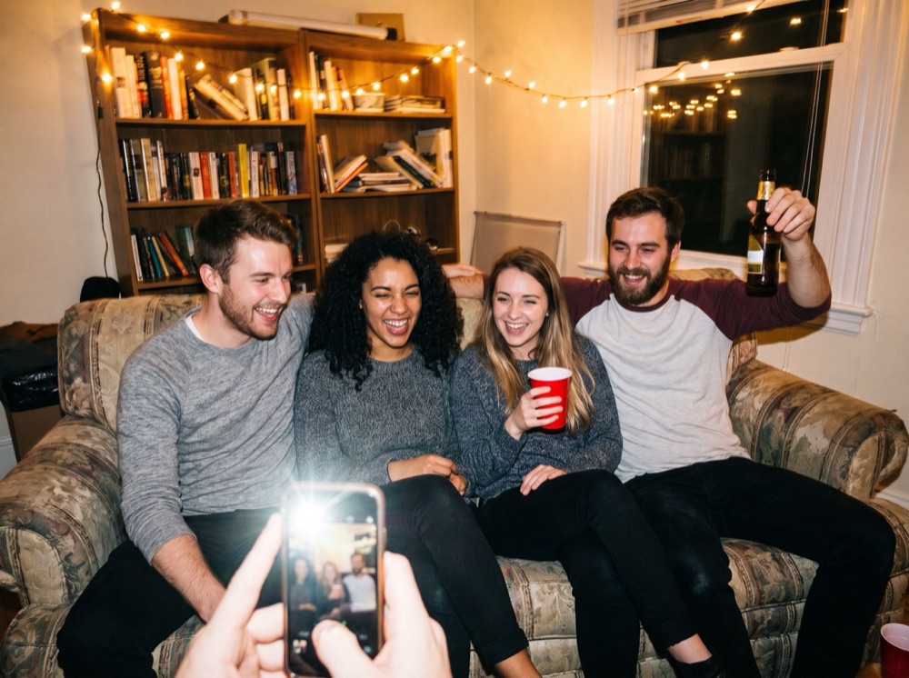 The original photo: four friends laughing on a couch